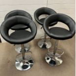 Four faux leather bar stools