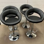 Four faux leather bar stools