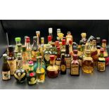 A collection of miniature bottle spirits and liqueurs including Johnie Walker whisky, port, brandy