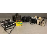 A collection of various cameras and camera cases