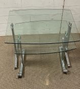 A pair of glass and chrome nesting tables