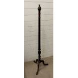 A mahogany stand lamp on tripod legs