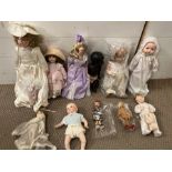 A collection of dolls, various ages and sizes