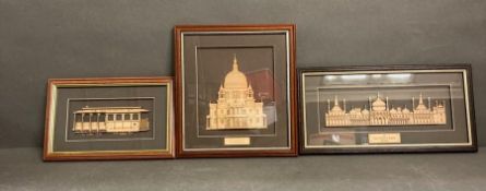 A trio of framed wooden carvings