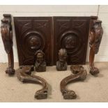 Two renaissance style panels along with two carved heads and four decorative cabriole legs