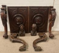 Two renaissance style panels along with two carved heads and four decorative cabriole legs