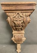 A carved wall sconces, depicting a lions face