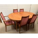 A six seater dining room table with four chairs and two carvers