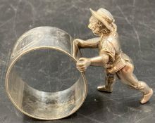 A napkin ring with a child pushing it