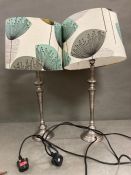 A pair of lamps with dandelion print lamp shades