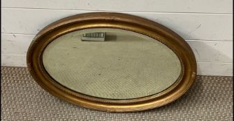 An oval gilt mirror (52cm)