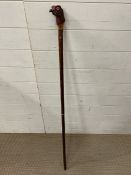 A shooting stick with carved red grouse head, stamped CW and Splits for transportation