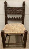 A carved oak chair with rush seating (H72cm)