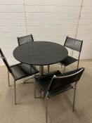 A four seater Mid Century style black marble and chrome kitchen table and string chairs (H73cm