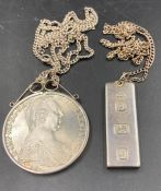A mounted Maria Theresa coin 1780 in a necklace mount along with a hallmarked silver ingot necklace