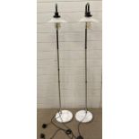 A pair of marble base floor lamps with glass shades