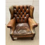 A Chesterfield leather wing back armchair