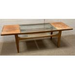 A Mid Century glass topped coffee table with shelf under (H42cm W140cm D52cm)