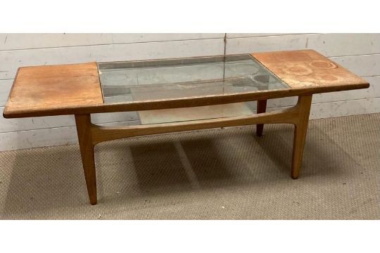 A Mid Century glass topped coffee table with shelf under (H42cm W140cm D52cm)