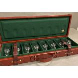 A leather travelling shooting case with eight sherry glasses by Rev Pavon