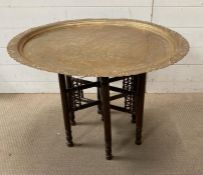 An antique brass tea table