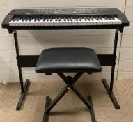 A Zennox keyboard on stand with stool