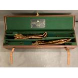 A Holland and Holland leather gun case with felt fitted interior and brass lock