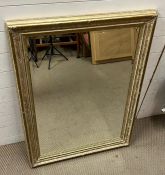 A wall mirror with foliage motif to corners