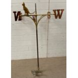 A brass weather vane with cooper compass points and a cat overseeing (H127cm Dia105cm)