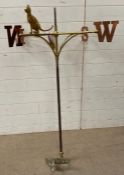 A brass weather vane with cooper compass points and a cat overseeing (H127cm Dia105cm)