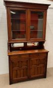 A mirrored back dresser with glazed bookcase top and a cupboard below (H224cm W124cm D50cm)