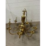 A large brass eight scroll arm chandelier (approx 75cm x 75cm without chain)