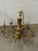 A large brass eight scroll arm chandelier (approx 75cm x 75cm without chain)