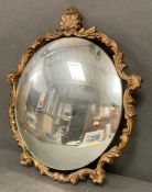 A circular gilt framed mirror