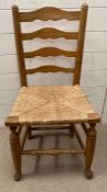 A pine ladder back chair with rattan seat