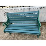 A Victorian style garden bench with cast iron ends