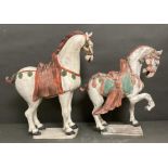 A pair of large terracotta horses in the Tang style.