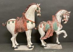 A pair of large terracotta horses in the Tang style.