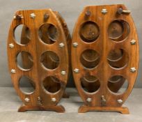 A pair of barrel shaped wooden six bottle rack AF