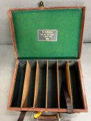 A Holland and Holland leather and brass banded cartridge case