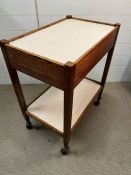 A vintage teak two tier trolley