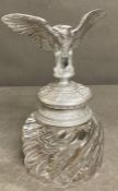 A glass inkwell with an eagle top