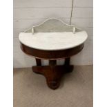 A marble top Demi Lune wash stand on mahogany base (H72cm W92cm D47cm)