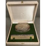 A silver backed brush and comb set, engraved christening set.