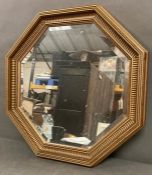 An octagonal gilt frame mirror