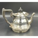 A silver teapot with flora decoration, hallmarked for Sheffield, makers mark for Lee & Wigfull (