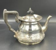 A silver teapot with flora decoration, hallmarked for Sheffield, makers mark for Lee & Wigfull (