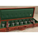 A red leather travelling shooting case of eight drinking glasses by Rev Pavon