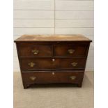 A two over two chest of drawers (H76cm W93cm D42cm)
