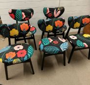 A set of five G-Plan butterfly back chairs with ebonised frames and gold manufacturers marks.